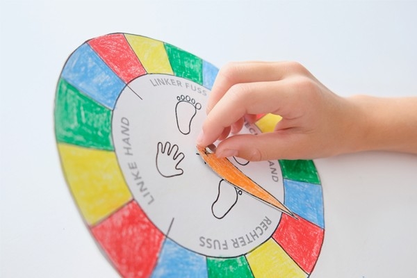 Twister – Kind befestigt Zeiger auf Vorlage