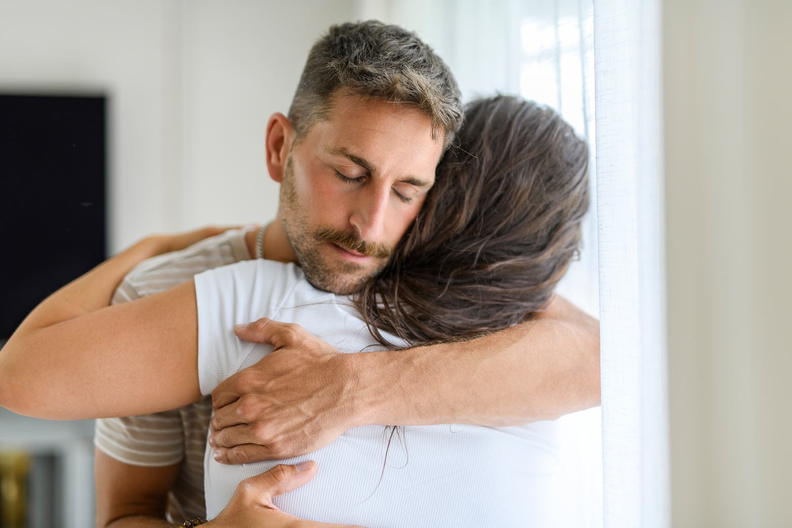 Miscarriage – a man and woman in a tight, meaningful embrace