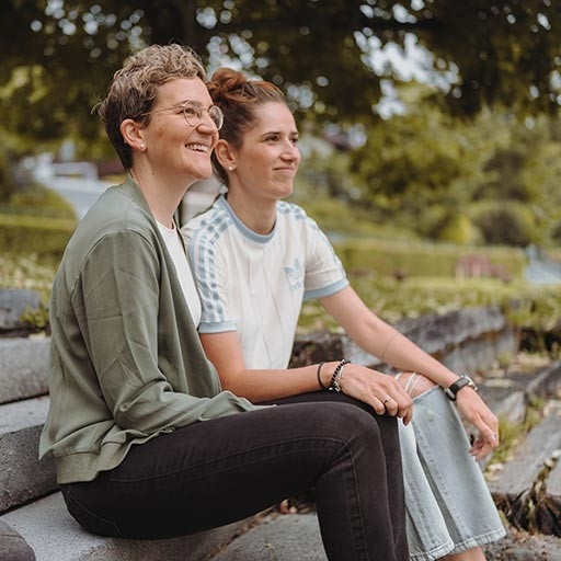 Life situations - Father and son hold a ball together, while the mother laughs in the background
