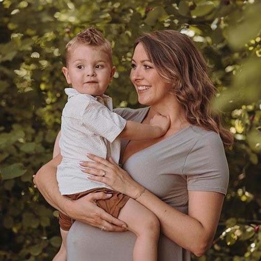 Life situations - A laughing baby lies on the bed