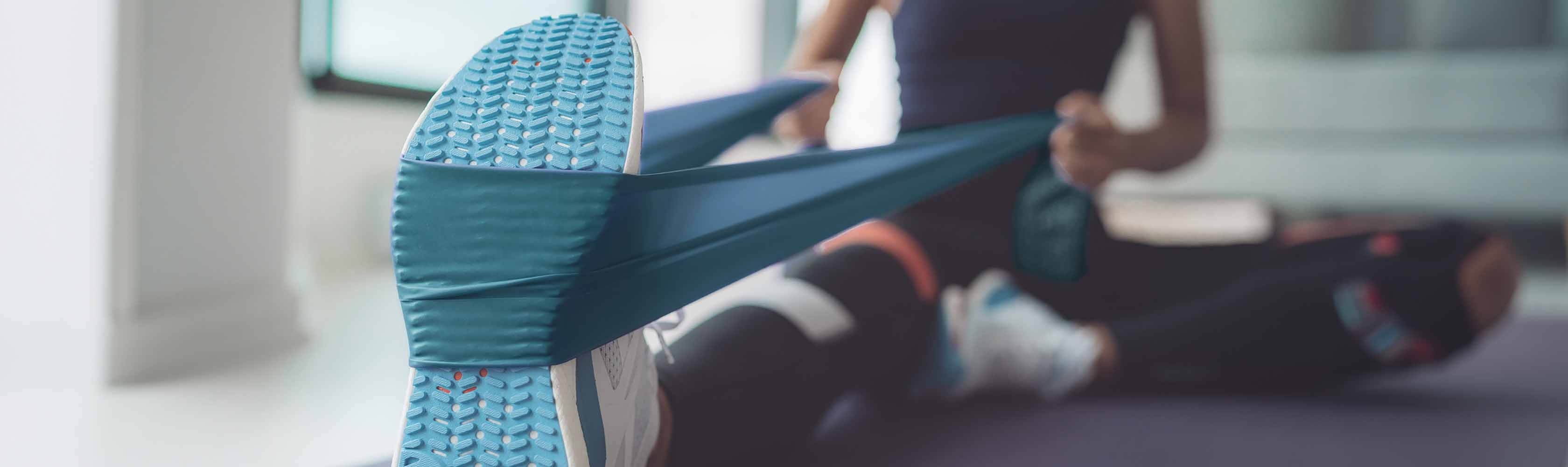 Commande de bande fitness - Une bande fitness CONCORDIA est tendue sur une chaussure de sport