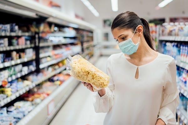 Le etichette alimentari ci guidano nella scelta di prodotti equi e solidali. Una donna legge l'etichetta di una confezione di pasta.